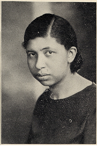 Three-quarters head-and-shoulders view of a woman with her hair parted on the side.