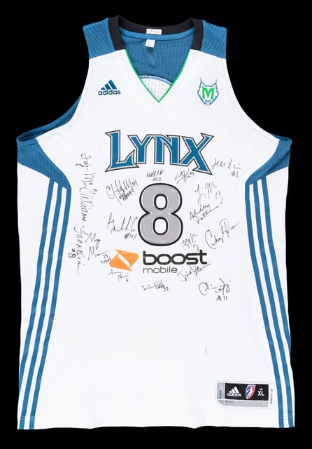White basketball jersey with blue details, the word "Lynx," and the numeral, with a black background.