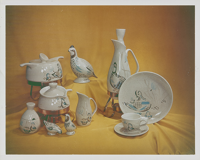 White ceramic items sit staged against a yellow cloth backdrop.