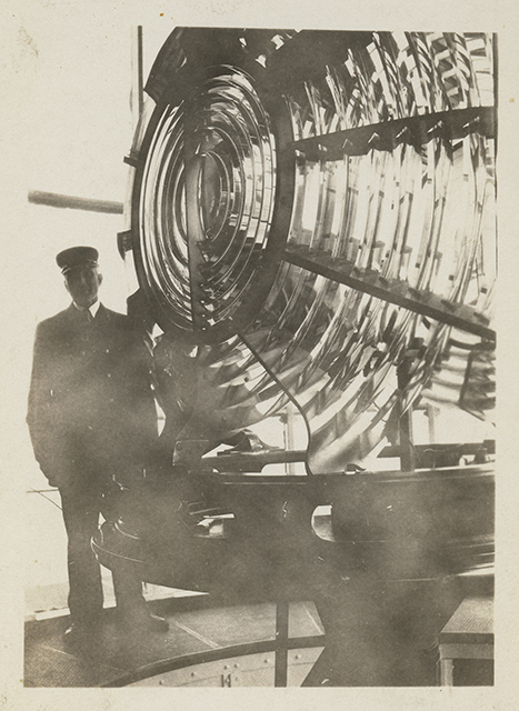Black and white photograph of Franklin J. Covell by the Split Rock Lighthouse lens.