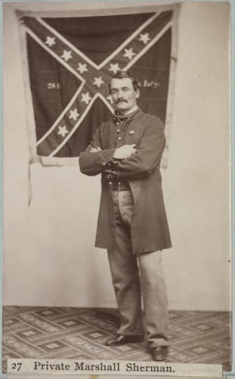 Marshall Sherman standing with the Twenty-eighth Virginia battle flag