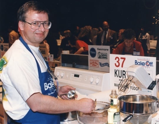 Color image of Bake-Off Winner Kurt Wait (Redwood City, CA) baking macadamia fudge torte. He was the first and only male grand prize winner, 1996.