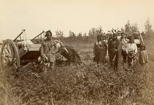 Black and white photograph of Ojibwe with Red River carts near Fort Dufferin, Manitoba, Canada,