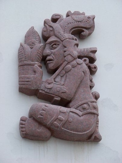 Color image of a corn god holding an ear of corn. Photograph by Wikimedia Commons user ŠJů, 2012.