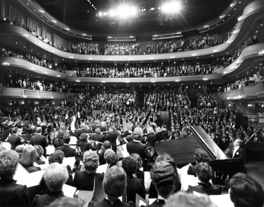 Black and white photograph of the SPCO playing “The Star Spangled Banner” at its Ordway debut concert, 1985.