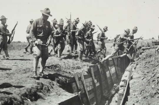 Black and white photograph of candidates jumping over an entrenchment at the Officers’ Training Camp, Fort Snelling, 1917.