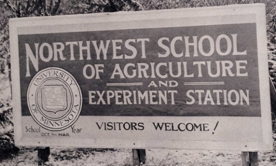 Black and white photograph of the entrance sign for the Northwest School of Agriculture and Northwest Experiment Station.