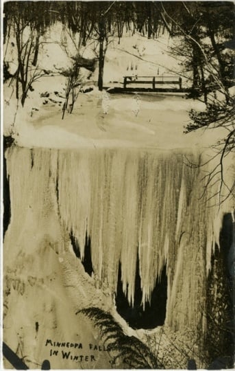 Blacka nd white photograph of of Minneopa Falls on the Minneopa River in winter, ca. 1920.