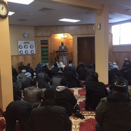 Color image of Friday prayer at Dar Al-Hijrah Mosque, 2015.