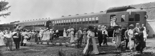 Black and white photograph of the arrival of one of the picnic trains of the Dan Patch Electric Line at Antlers Park, c.1912.