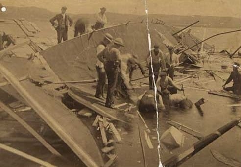 Black and white photograph of rescue workers searching for bodies in the wreckage of the Sea Wing, 1890.
