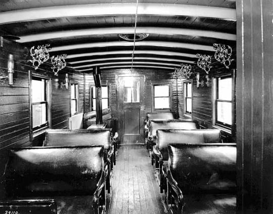 Black and white photograph of the interior of passenger coach on St. Paul and Pacific Railroad, 1875.