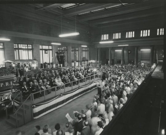 Black and white photograph of speaker’s stand and crowd at the 100th anniversary celebration of the Great Northern Railway at St. Paul’s Union Depot, 1962.