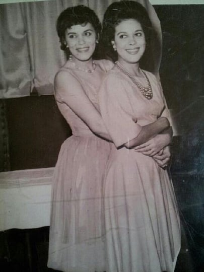 Black and white photograph of Hilda Simms (right) posed with one of her younger sisters, Laura, c.1955.