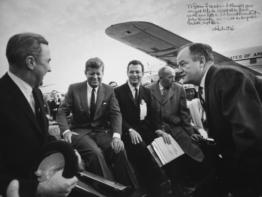 Black and white photograph of President John F. Kennedy at the Duluth airport with Senator Eugene McCarthy, Representative Donald Fraser, Governor Karl Rolvaag, and Senator Hubert H. Humphrey, 1965.