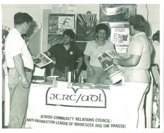 Black and white photograph of booth staffed by members of the JCRC/ADL at the Minnesota State Fair, c.1986.