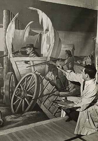 Black and white photograph of artist John Socha at work on a Works Progress Administration mural at the New Ulm High School, 1941.