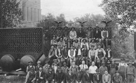 Black and white photograph of workers posed by Pillsbury “A” Mill in Minneapolis, ca. 1918.