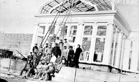 Black and white photograph of construction workers in front of the conservatory, ca. 1915.