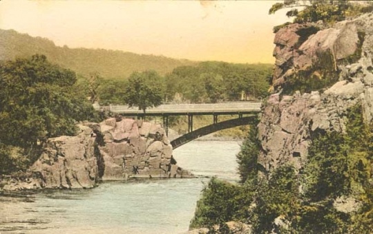 Colorized post card view of Old Man of the Dalles of the St. Croix and bridge over the river, 1920.
