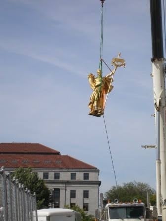 Color image of the figure of Prosperity being removed for restoration, September 23, 2014. Photographed by Linda A. Cameron.
