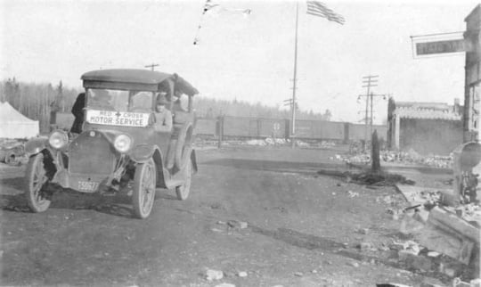 Black and white photograph of Red Cross Motor Service car providing relief efforts after the October fires of 1918.