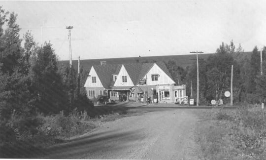 Black and white photograph of Stickney Inn and Store, facing south, from Cramer Road, with gas station at right, ca. 1940.