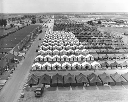 Black and white photograph of tents and hutments at Camp Ripley, 1965.