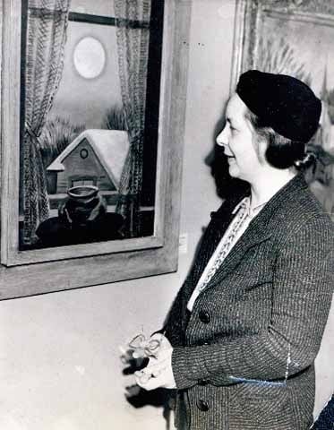 Black and white photograph of Elsa Laubach Jemne viewing Clement Haupers’ oil painting Early Moon in St. Paul, 1938.