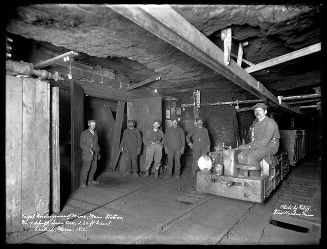 Black and white photograph of miners inside the Fayal mine in Eveleth, 1915. Photographed by William F. Roleff.