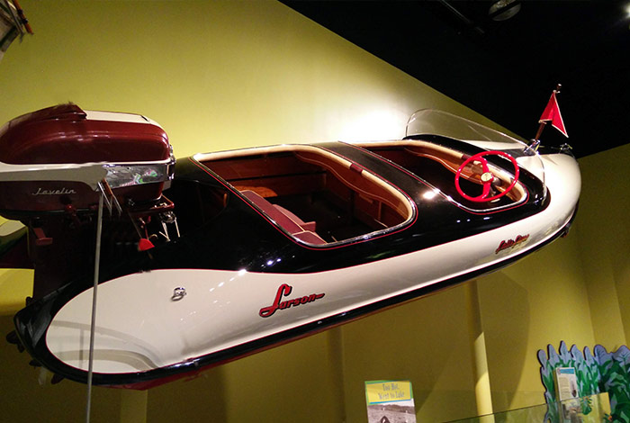A 1956 model "Falls Flyer." A molded fiberglass boat with a twin cockpit and round hull.