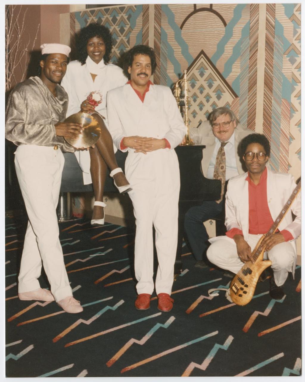 Kirk Johnson in gold shirt (far left); Kim Johnson (piano); Wendell Thomas ( bass, far right). Photographer: Chamblis, Charles Collection I.368.29.