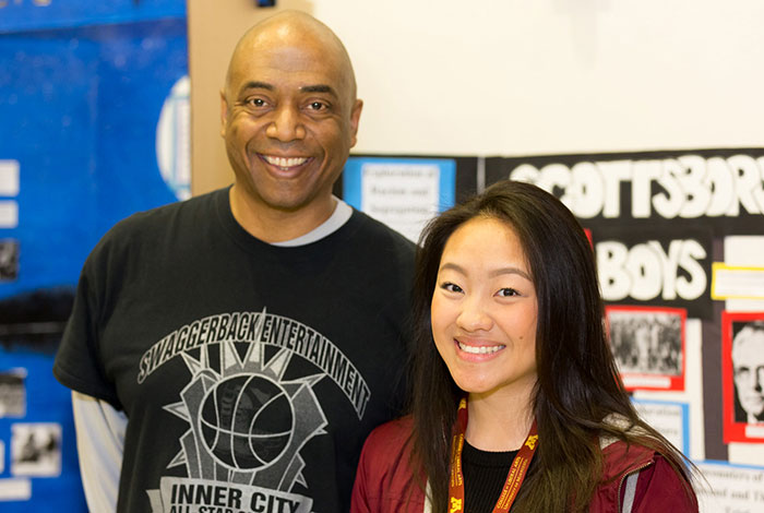 teacher standing with student