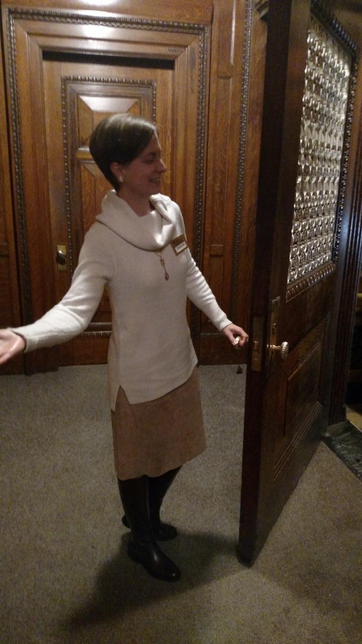 Woman opening door from the inside of the James J. Hill House