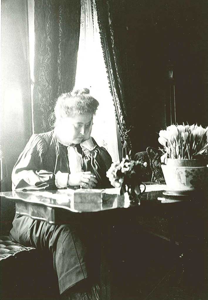 A woman seated at a desk looking at papers