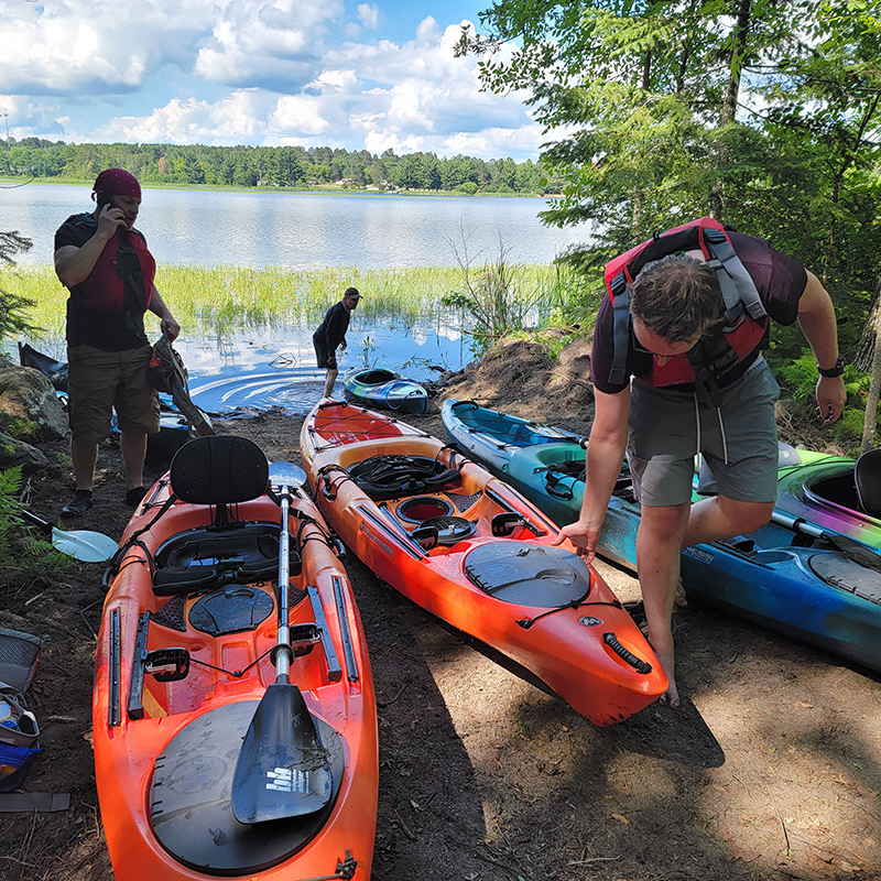 Kayaks on lakeshore.
