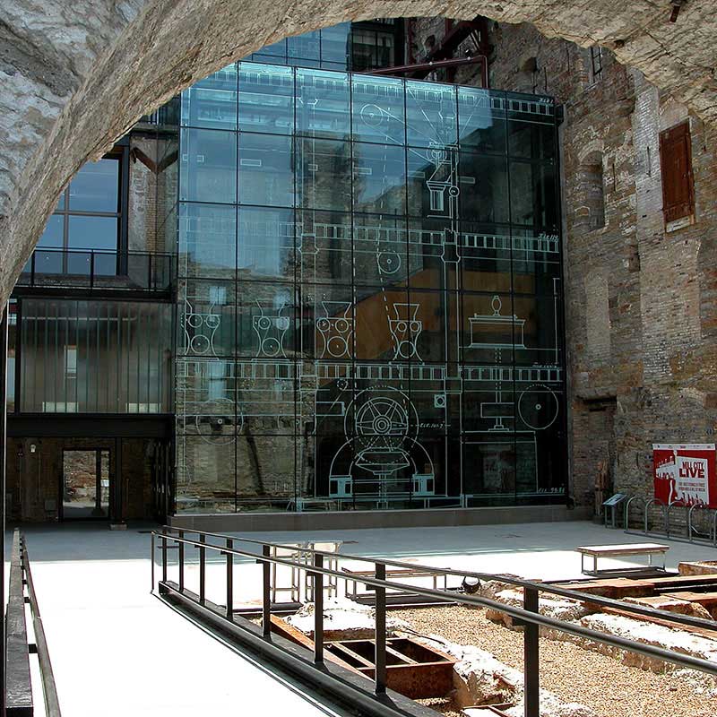 Looking through an arched doorway towards the outside ruins and museum.