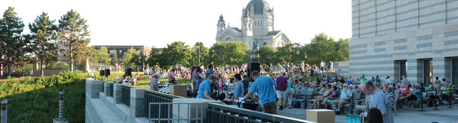 A crowd gathered outside of the Minnesota History Center on a summer day.