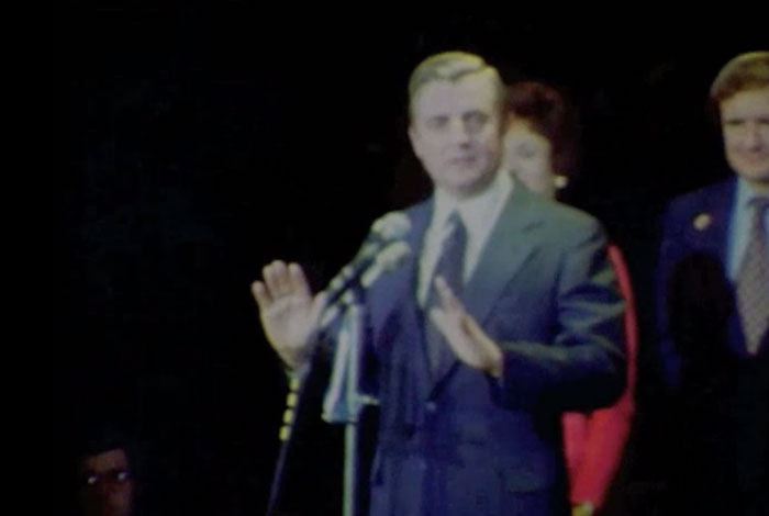 Walter Mondale standing behind microphone.