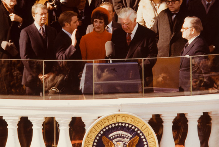Speaker of the House Tip O'Neill administers the vice presidential oath of office to Walter Mondale as Hubert Humphrey, Jimmy Carter, Joan Mondale and others look on.