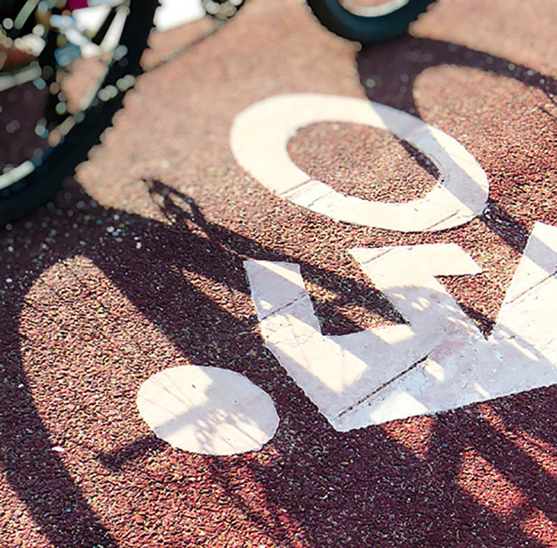 Shadow of a bicycle on a road.