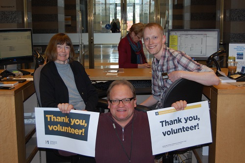 Staff and volunteers at the Gale Library holding up signs that read, "thank you volunteers."