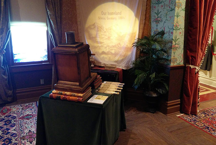 An antique projector sits propped up on books in the parlor.