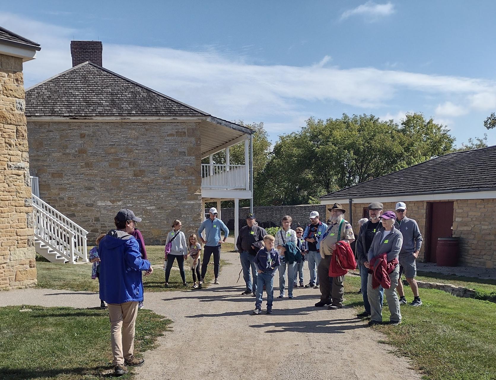 A tour guide leads a group through the Historic Fort Snelling grounds.