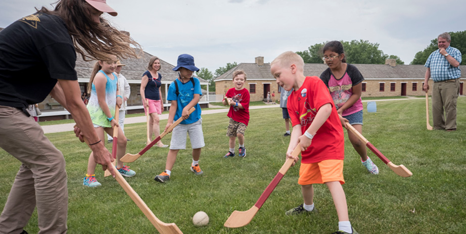 children playing field hockey