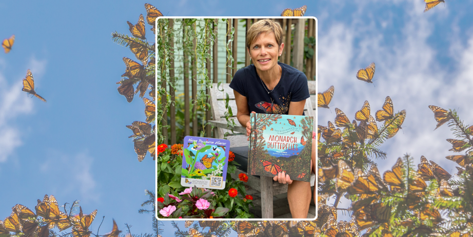 Author holds a copy of her book Monarch Butterflies amidst flowers