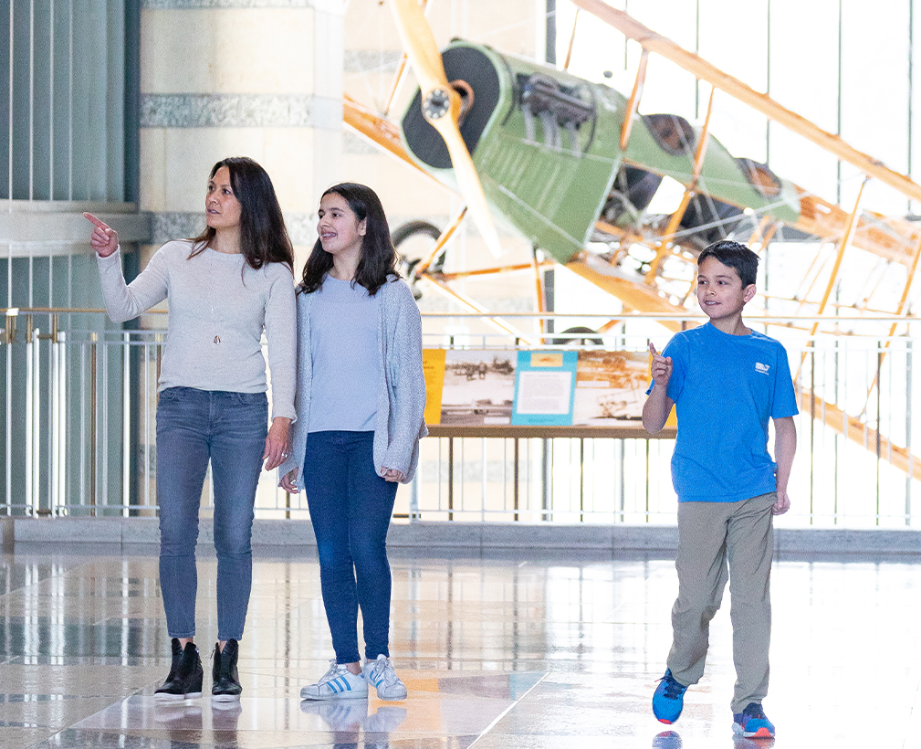 Family standing in a museum.