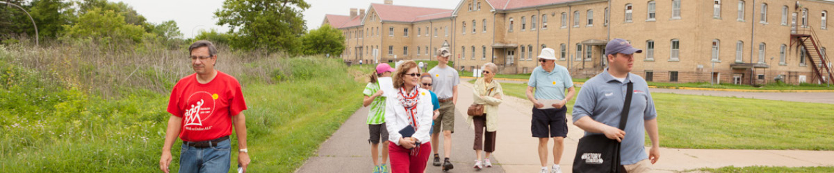 A tour group follows a Fort Snelling guide past the historic barracks. 