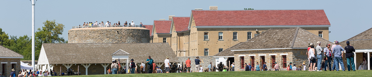 The Round Tower and surrounding buildings on a busy day with many visitors. 