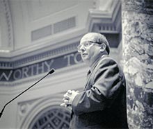 Senator Allan Spear speaking into a microphone.